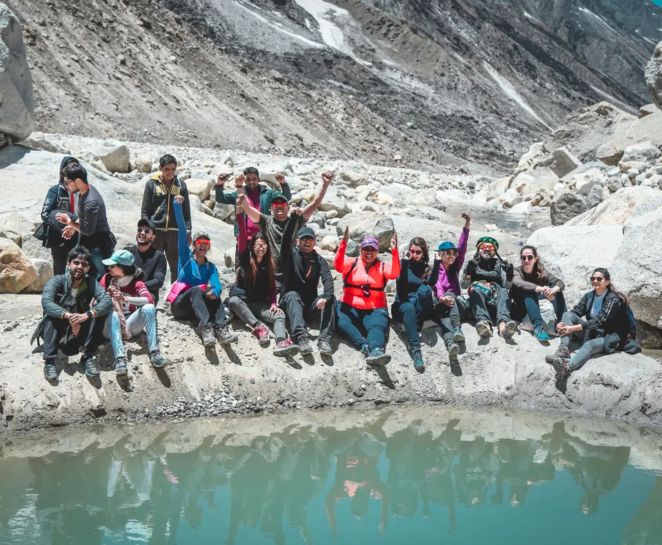 A Yoga Kiran retreat group beside a glacial pool in the Himalaya